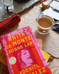 a cup of coffee and a book on a table