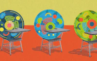 three colorful chairs with a desk in the middle